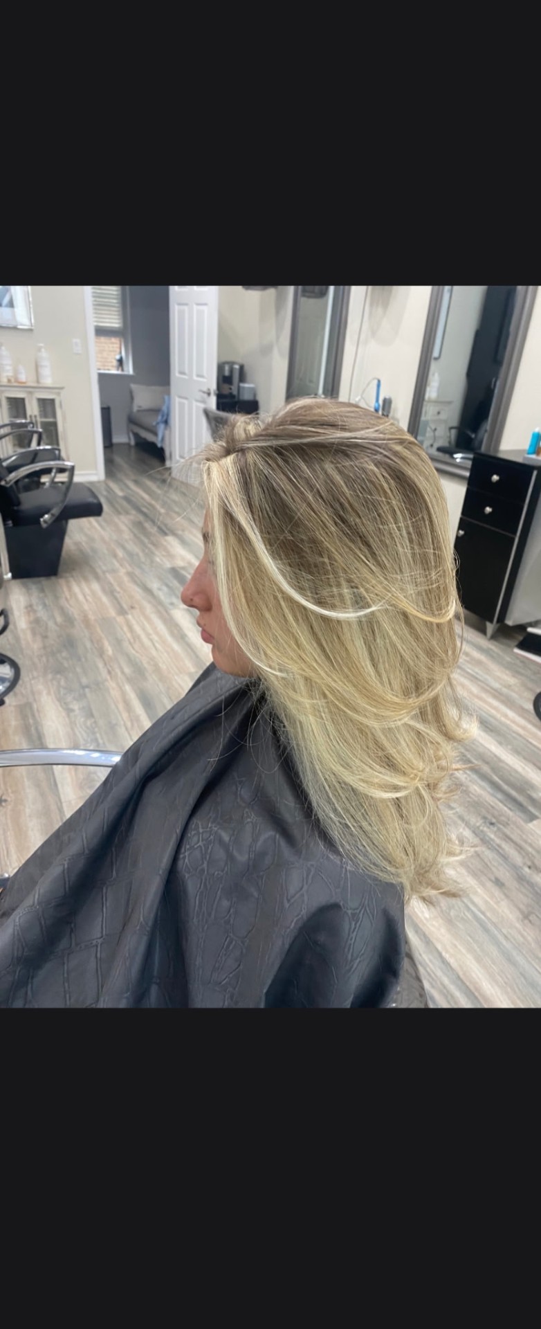 Layered bob with warm highlights styled at Phyllis Salon